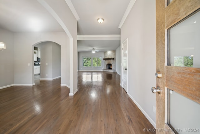 entrance foyer featuring a fireplace and dark hardwood / wood-style floors