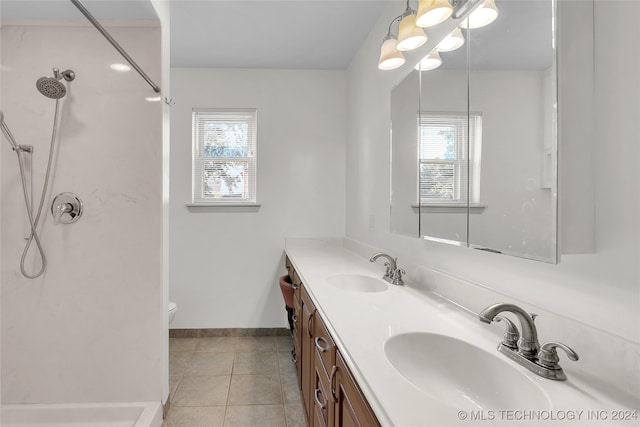 bathroom with tile patterned flooring, walk in shower, vanity, and toilet