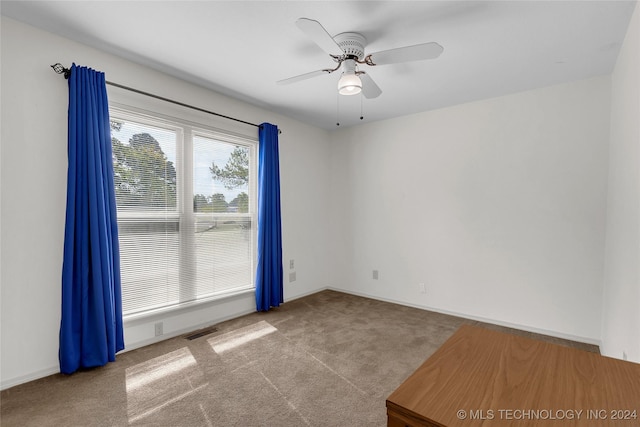 spare room with ceiling fan, baseboards, visible vents, and carpet floors