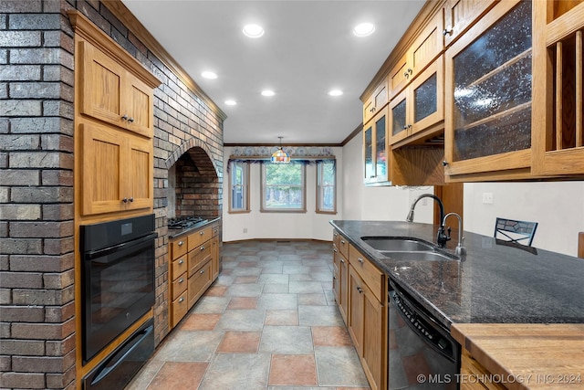 kitchen featuring glass insert cabinets, a sink, crown molding, a warming drawer, and black appliances
