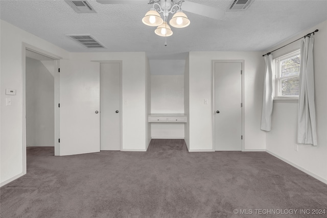 unfurnished bedroom featuring ceiling fan, a textured ceiling, and carpet flooring