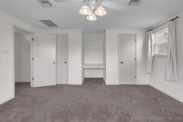 unfurnished bedroom with visible vents, carpet flooring, and a textured ceiling
