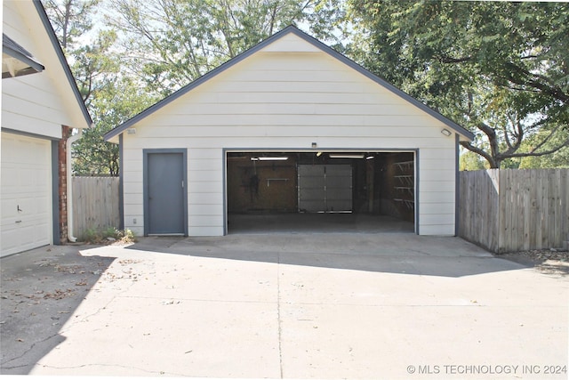 detached garage featuring fence