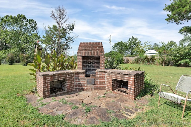 view of patio with an outdoor brick fireplace