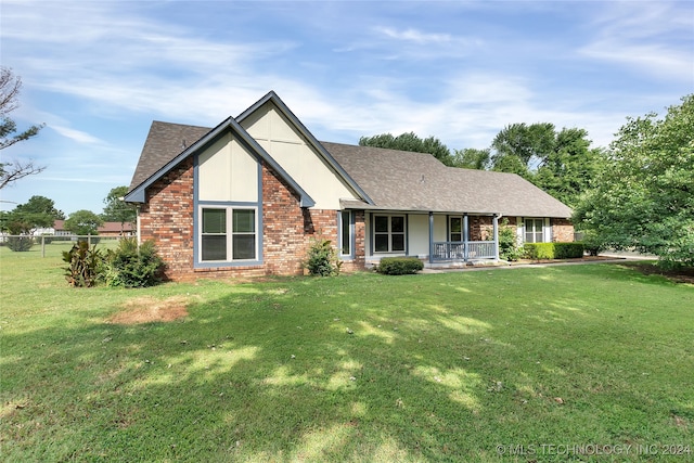 view of front facade featuring covered porch and a front yard