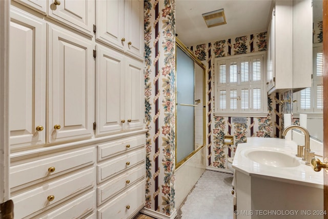 4108 S Saint Louis Ave, Tulsa, OK 74105 - full bath featuring wallpapered walls, combined bath / shower with glass door, and vanity