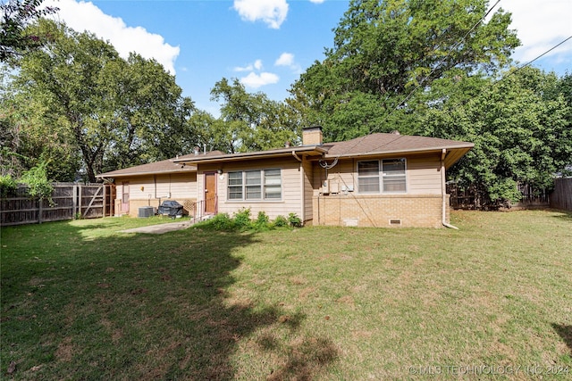 4108 S Saint Louis Ave, Tulsa, OK 74105 - back of property featuring a chimney, brick siding, and central AC unit