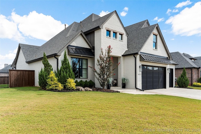 view of front of property with a garage and a front yard