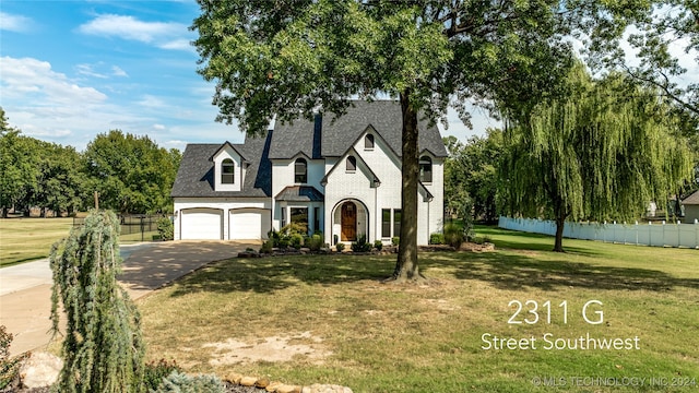 view of front of house with a front yard and a garage