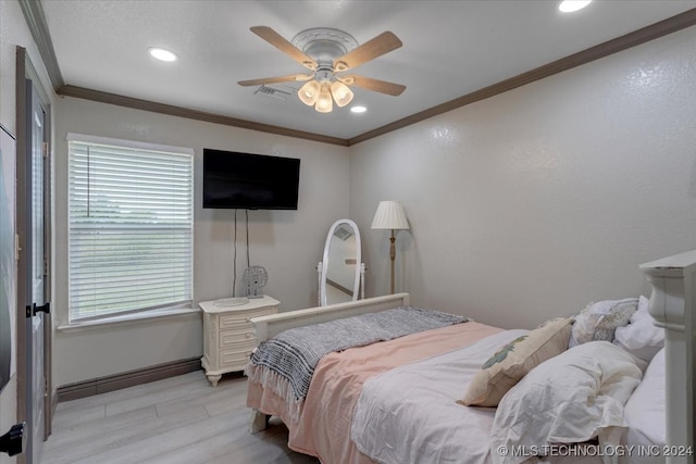 bedroom featuring ceiling fan, light hardwood / wood-style flooring, and ornamental molding