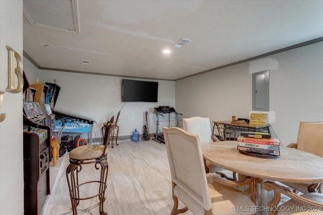 dining room with crown molding, light hardwood / wood-style floors, and electric panel