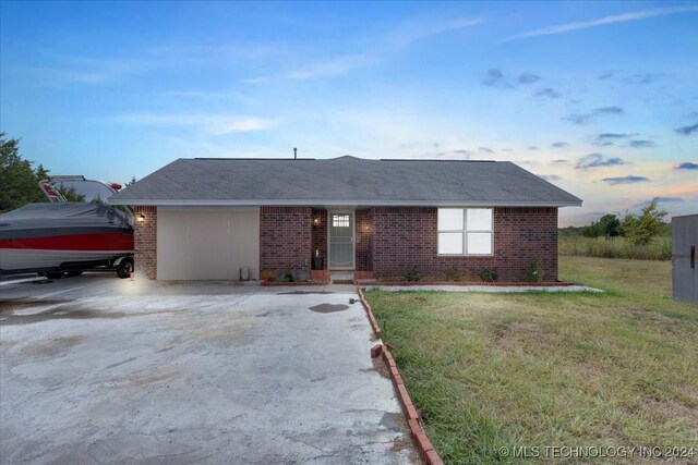 ranch-style house with a lawn