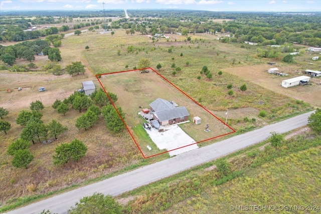 birds eye view of property with a rural view