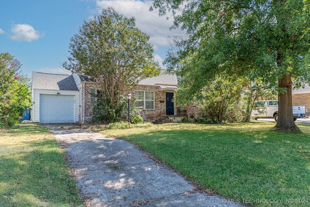 view of front of home with a front yard and a garage