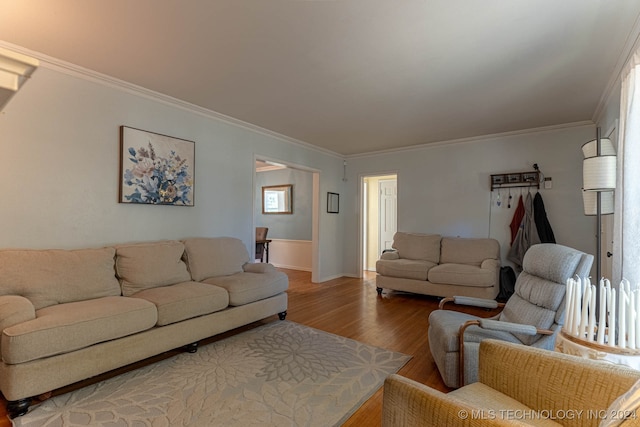 living room with ornamental molding and hardwood / wood-style floors