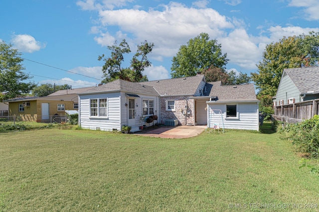 back of house featuring a patio area and a yard