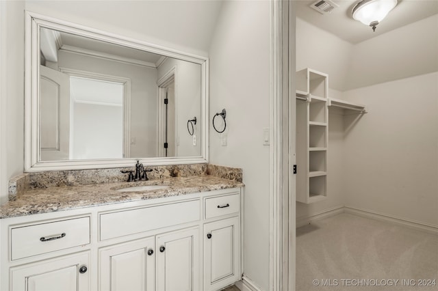 bathroom featuring ornamental molding and vanity