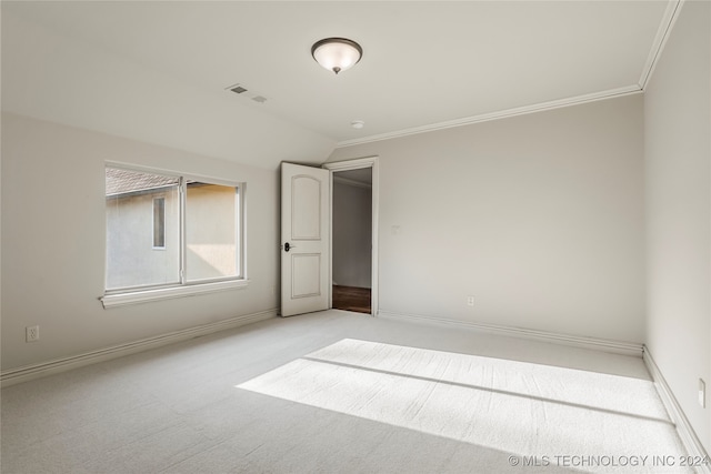 unfurnished room with light colored carpet and crown molding