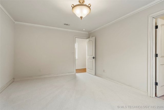 unfurnished bedroom featuring light colored carpet and ornamental molding