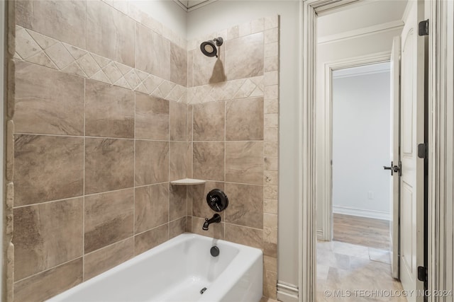 bathroom featuring tiled shower / bath combo and tile patterned flooring