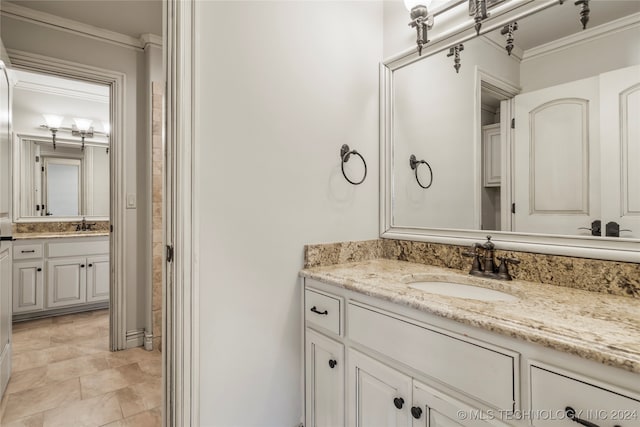 bathroom with crown molding and vanity