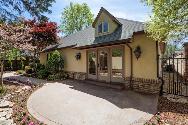 back of house featuring french doors, cooling unit, and a patio