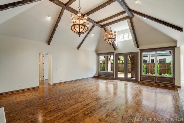 unfurnished living room with wood-type flooring, high vaulted ceiling, beamed ceiling, and a notable chandelier