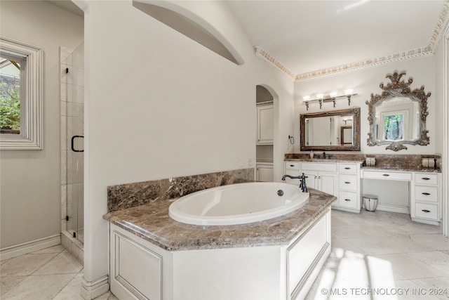 bathroom with tile patterned floors, independent shower and bath, and vanity