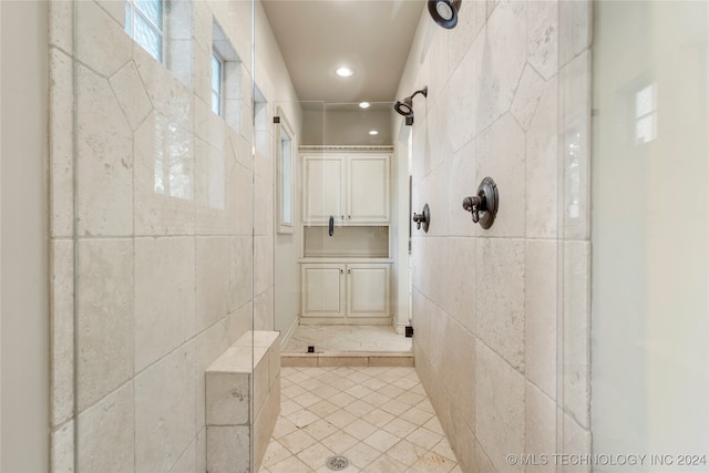 bathroom featuring tile patterned floors and tiled shower