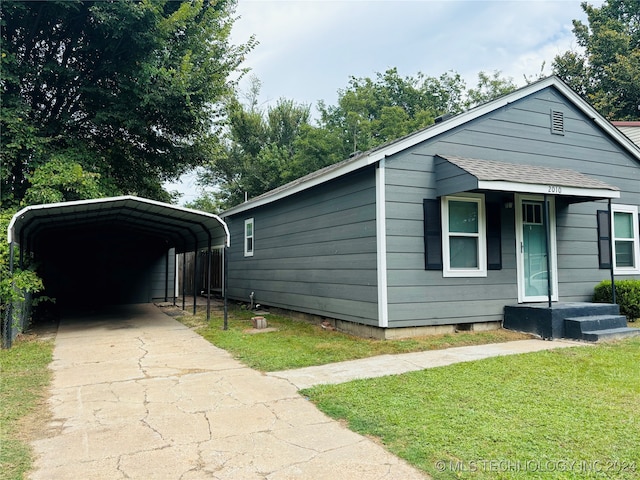 view of front facade with a front yard and a carport