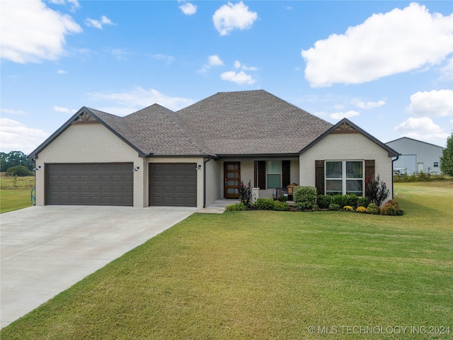 view of front facade with roof with shingles, concrete driveway, a front yard, an attached garage, and brick siding