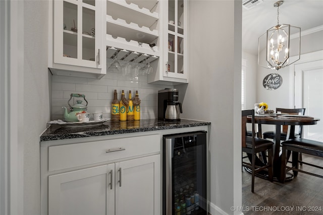 bar with beverage cooler, decorative light fixtures, white cabinetry, dark hardwood / wood-style floors, and decorative backsplash