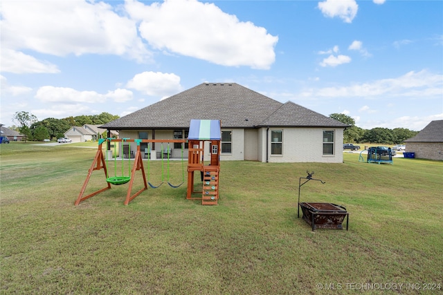 rear view of house featuring a playground and a lawn