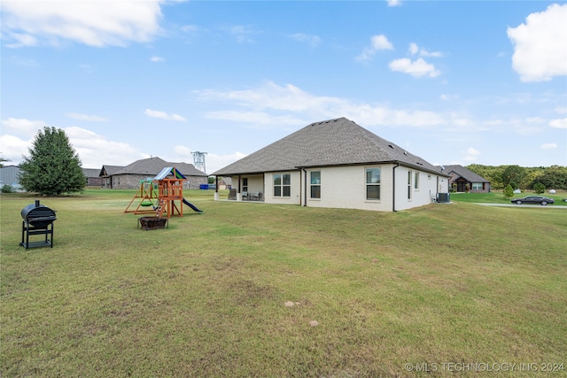 exterior space with a playground, cooling unit, and a lawn