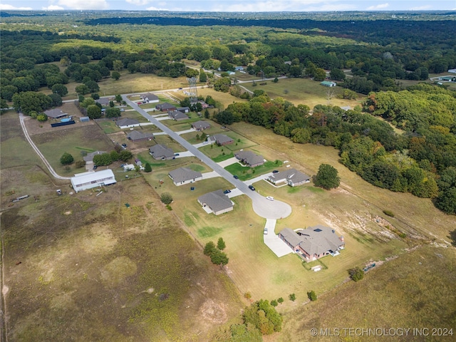 drone / aerial view featuring a view of trees