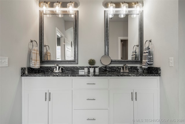 bathroom featuring double vanity and a sink