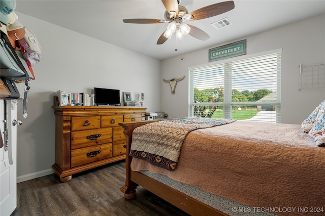 bedroom with visible vents, baseboards, ceiling fan, and dark wood-style flooring