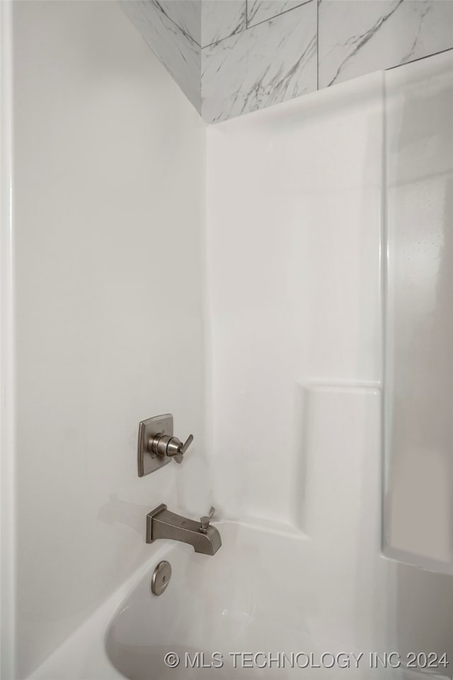 interior details with shower / tub combination