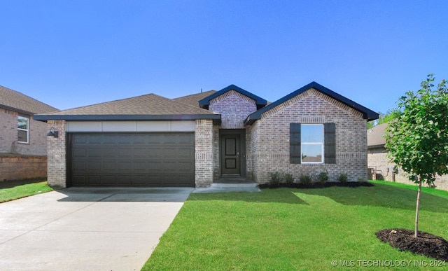 view of front of home with a front lawn and a garage