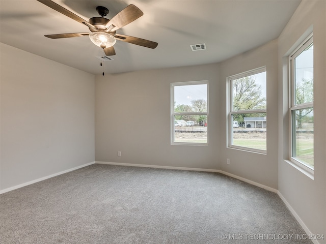 empty room featuring carpet and ceiling fan