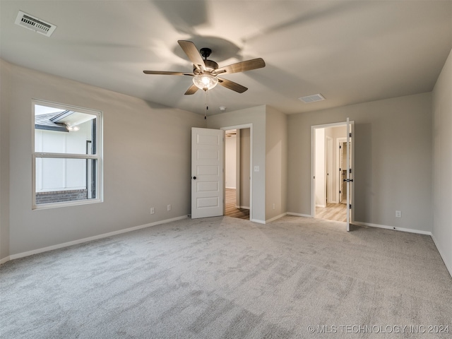 unfurnished bedroom with light carpet and ceiling fan