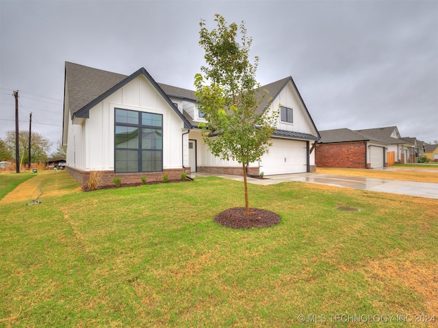 modern inspired farmhouse with a garage and a front yard