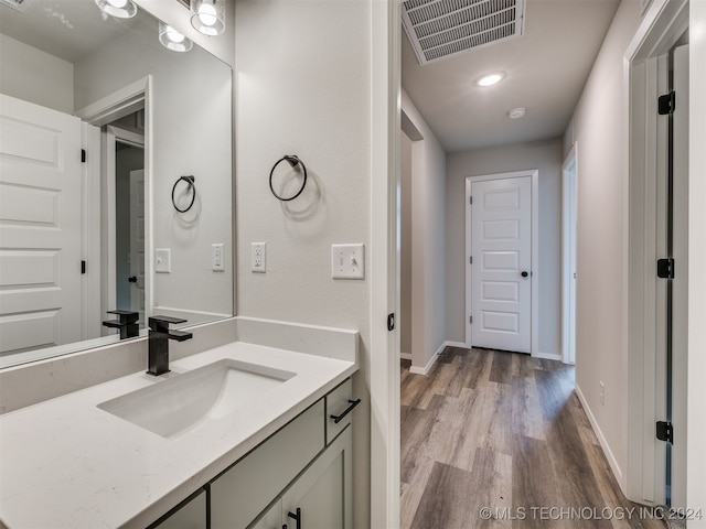 bathroom with hardwood / wood-style floors and vanity