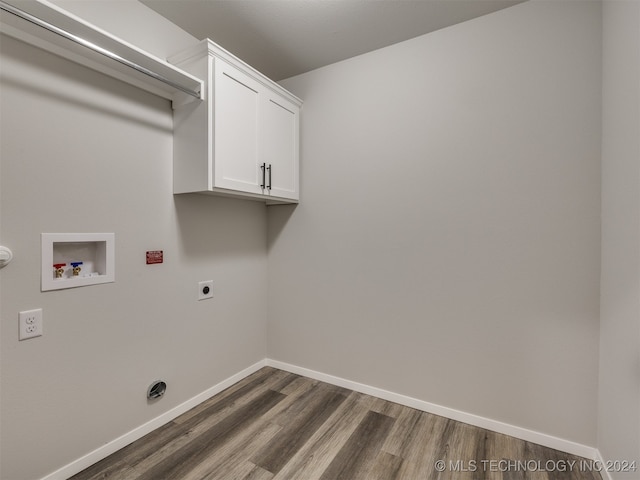 washroom with dark hardwood / wood-style flooring, washer hookup, cabinets, and hookup for an electric dryer