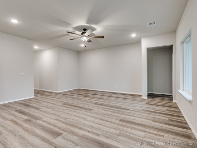 unfurnished room featuring ceiling fan and light wood-type flooring