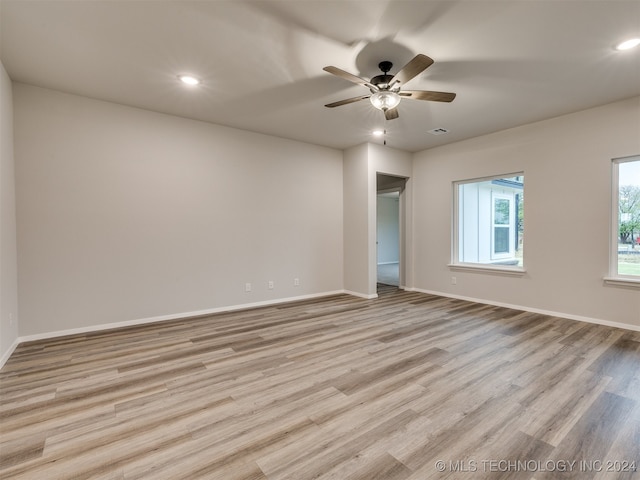 unfurnished room with ceiling fan and light hardwood / wood-style flooring