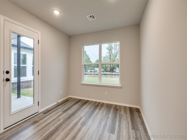 unfurnished room with light wood-type flooring