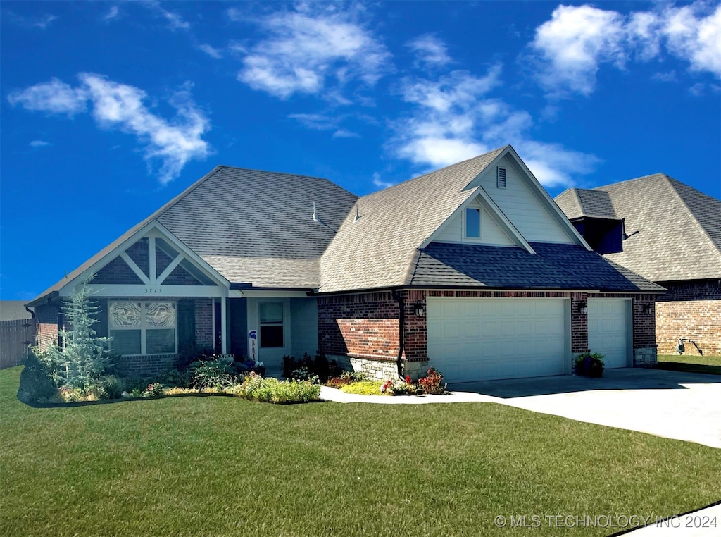 view of front facade with a front lawn and a garage