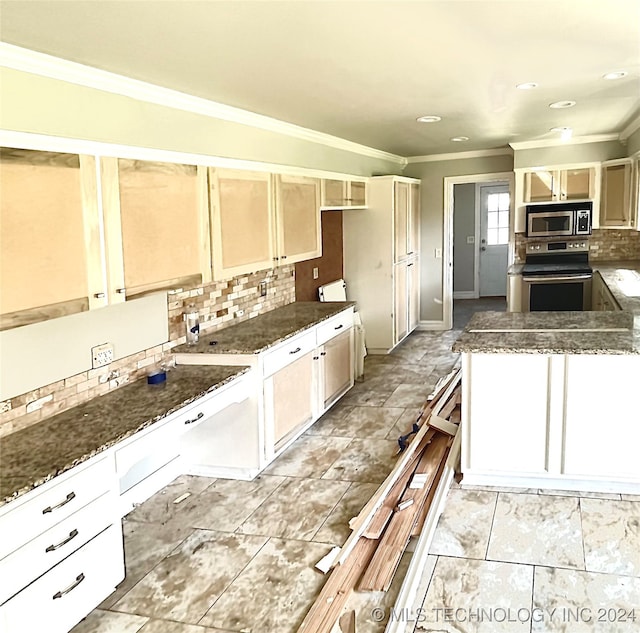 kitchen featuring decorative backsplash, stainless steel appliances, dark stone countertops, and crown molding