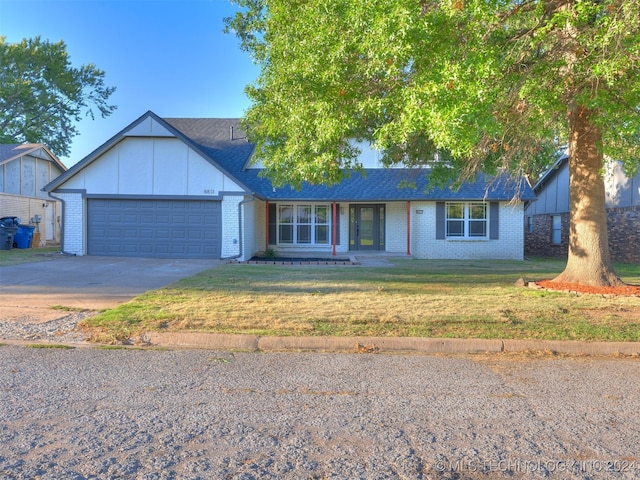 ranch-style house featuring a garage and a front yard